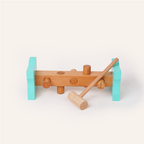 Wooden toy with turquoise wheels and a brown handle on a white background