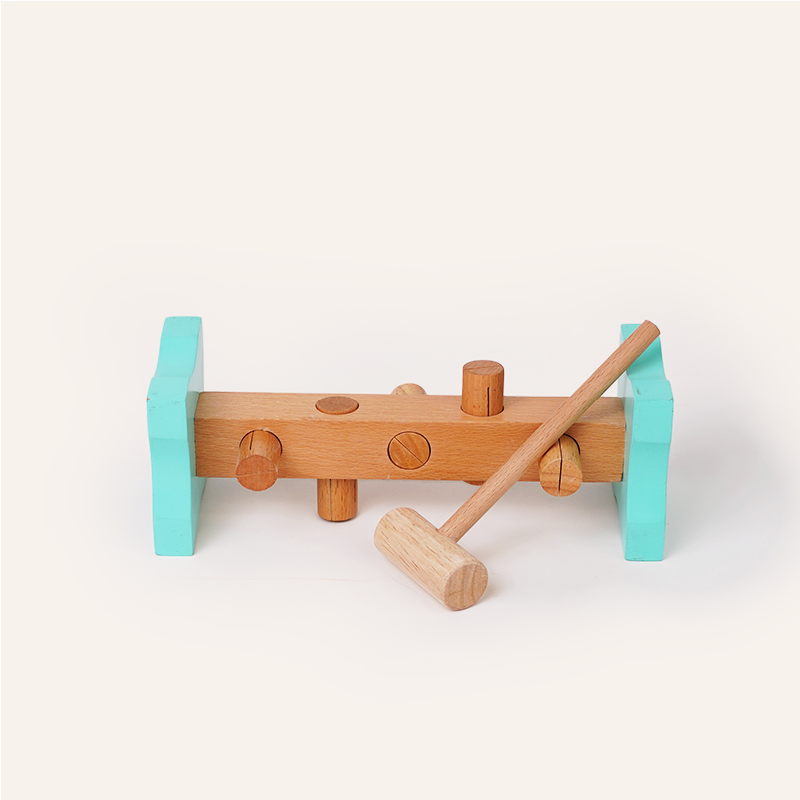 Wooden toy with turquoise wheels and a brown handle on a white background
