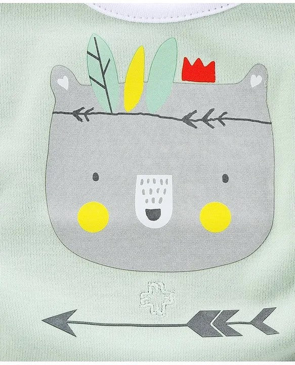 Bib with a cartoon bear face design on a light green background