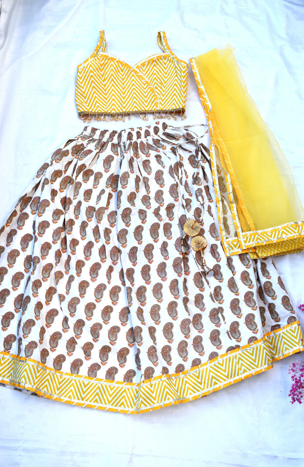 Yellow paisley lehenga with zig zag blouse and net dupatta