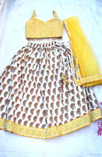 Yellow paisley lehenga with zig zag blouse and net dupatta