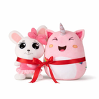 Two plush toys, one resembling a rabbit and the other a unicorn, tied with red ribbons on a white background.